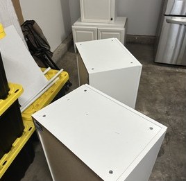 Wall cabinets with hanging hardware set before mounting