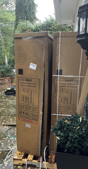 Two NewAge Bold garage cabinet boxes delivered outside a home