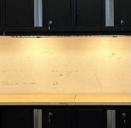 Undercabinet lighting over a garage workbench